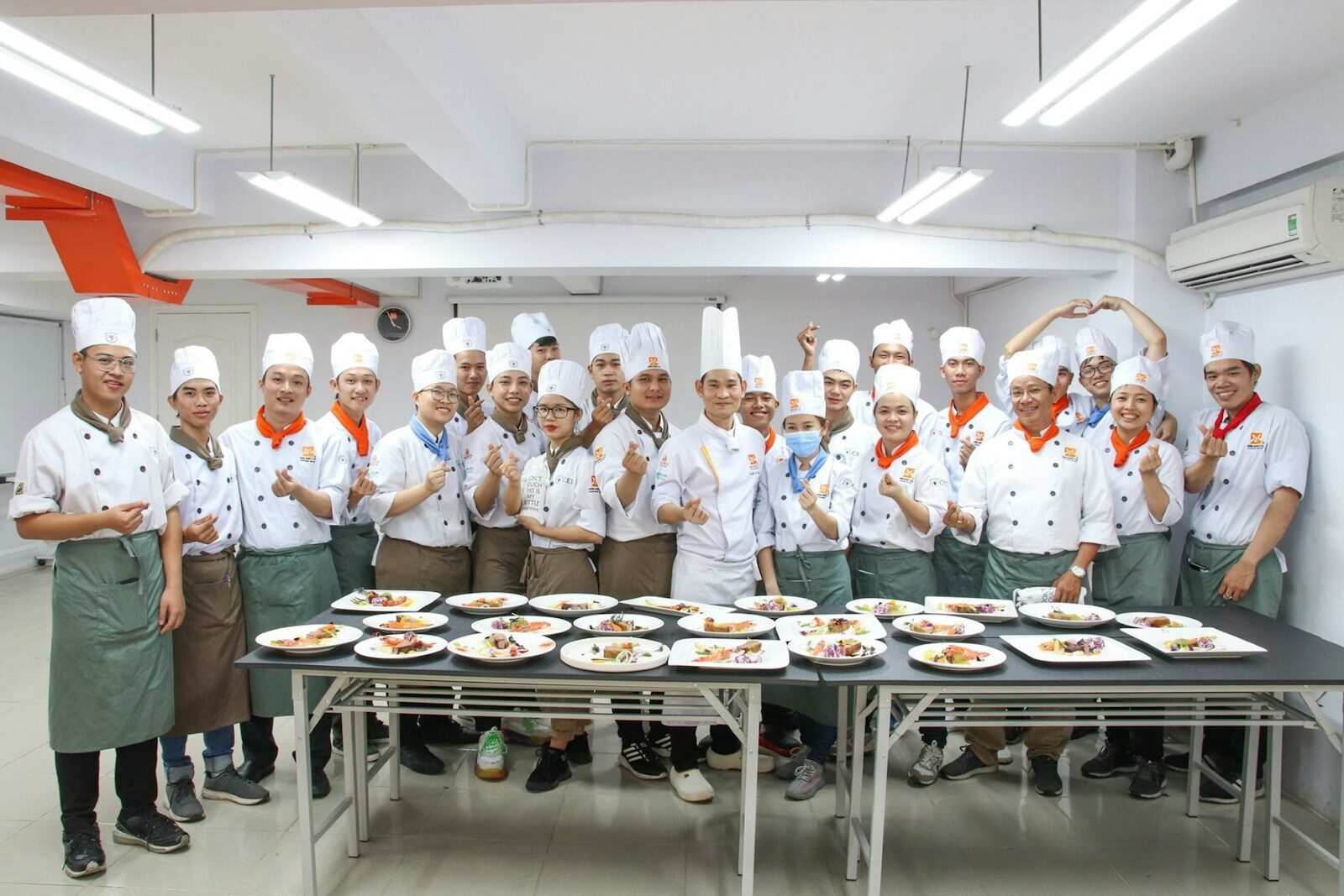 Photo by Trường Trung Cấp Kinh Tế Du Lịch Thành Phố Hồ Chí Minh CET group of chef standing beside table