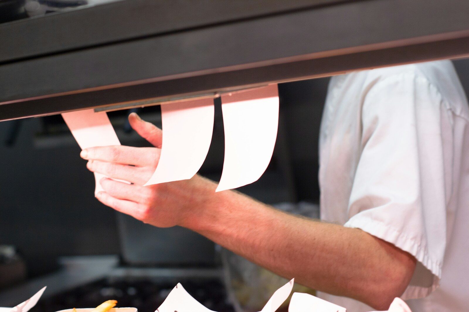 Photo by Daniel Bradley man holding white menu