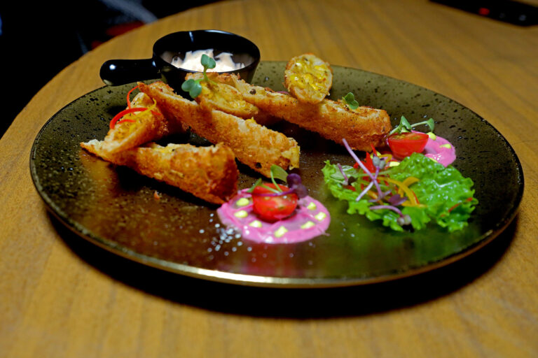 Crumb fried rolls served with a set of dips