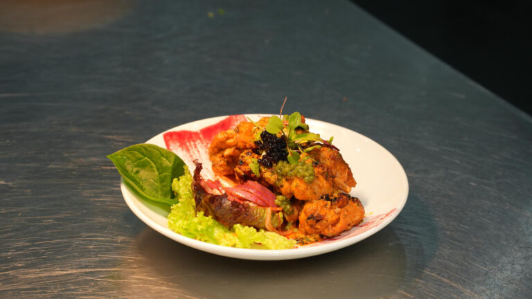 Kebabs and salad plated on white